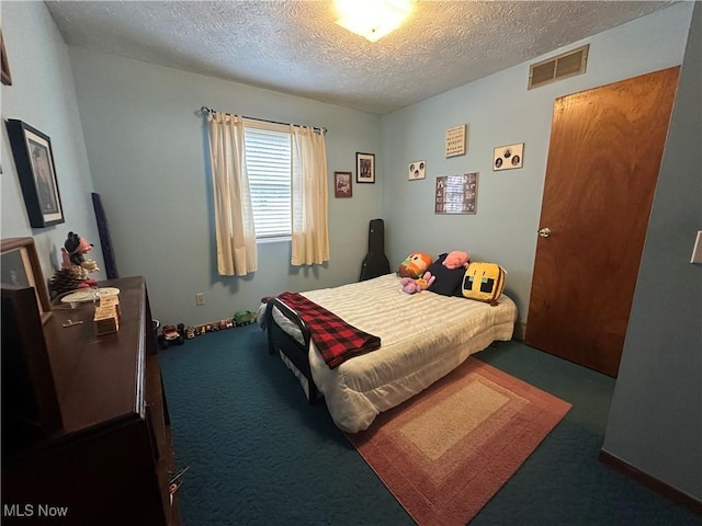 bedroom with a textured ceiling, visible vents, and carpet