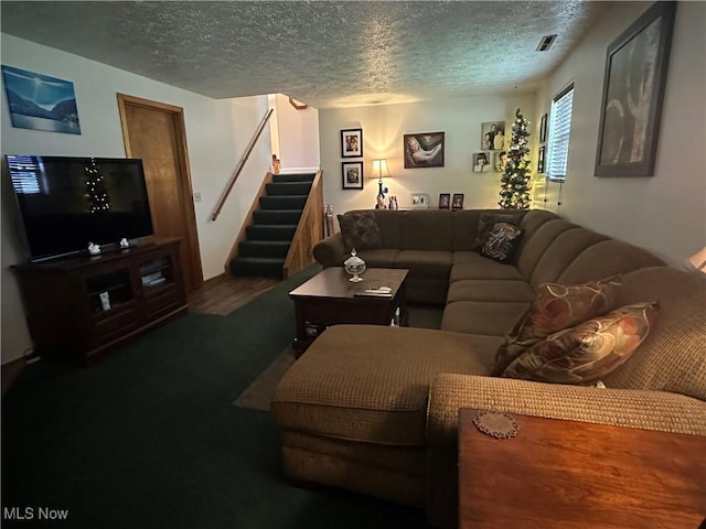 living room featuring stairway and a textured ceiling