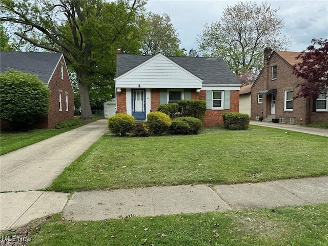 bungalow-style home with brick siding and a front lawn