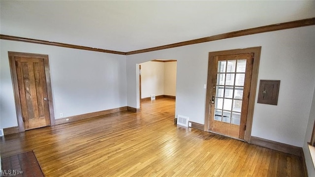 3996 Bluestone Rd, Cleveland Heights, OH 44121 - spare room with arched walkways, visible vents, ornamental molding, and light wood-style floors