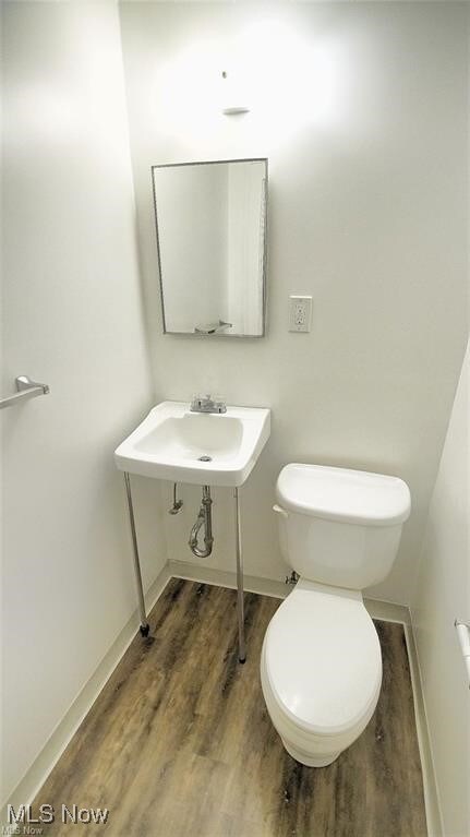 3996 Bluestone Rd, Cleveland Heights, OH 44121 - bathroom featuring baseboards, a sink, wood finished floors, and toilet