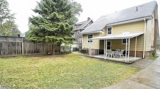 3996 Bluestone Rd, Cleveland Heights, OH 44121 - rear view of house with a fenced backyard, a patio, and a lawn