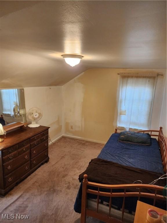 864 Davies Ave, Akron, OH 44306 - bedroom with baseboards, light colored carpet, multiple windows, and lofted ceiling
