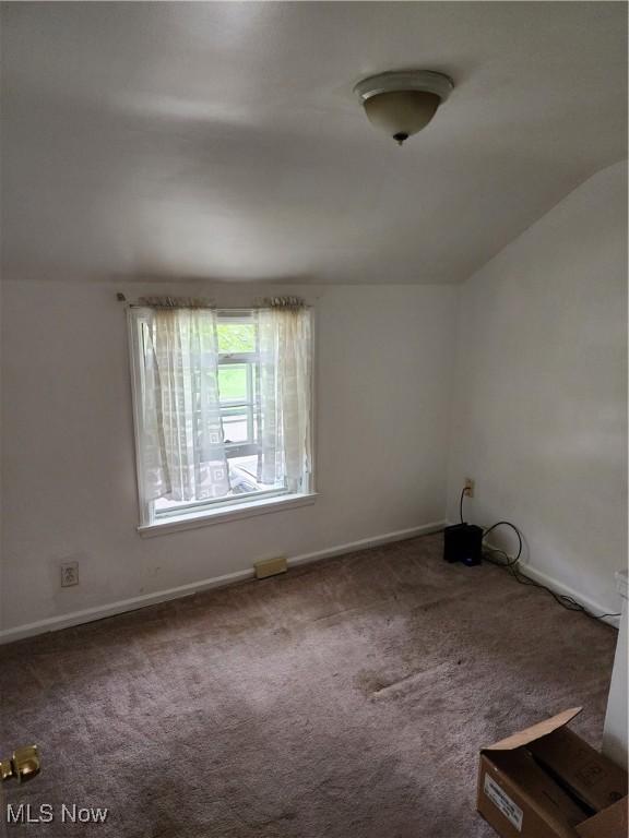 864 Davies Ave, Akron, OH 44306 - unfurnished room featuring baseboards, carpet, and lofted ceiling