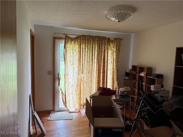919 19th St, Vienna, WV 26105 - dining area with light wood finished floors, a textured ceiling, and baseboards
