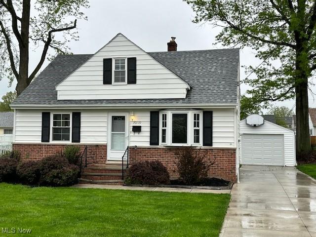 30119 Harrison St, Willowick, OH 44095 - view of front of property with a front lawn, brick siding, a chimney, an outdoor structure, and driveway