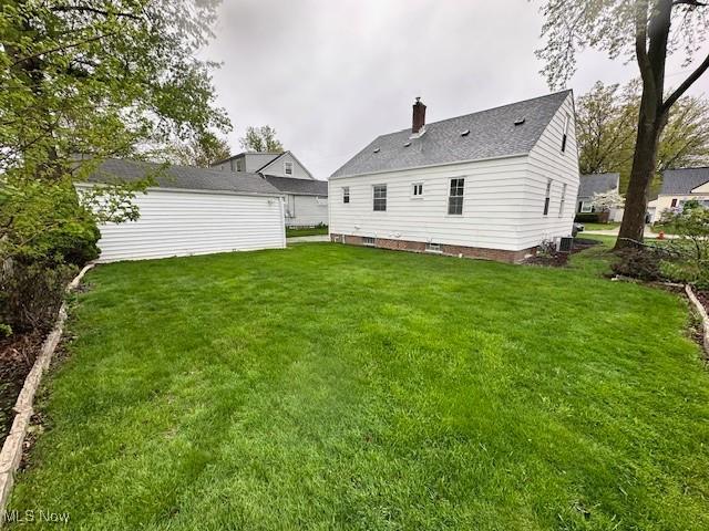 30119 Harrison St, Willowick, OH 44095 - rear view of property featuring a lawn and a chimney