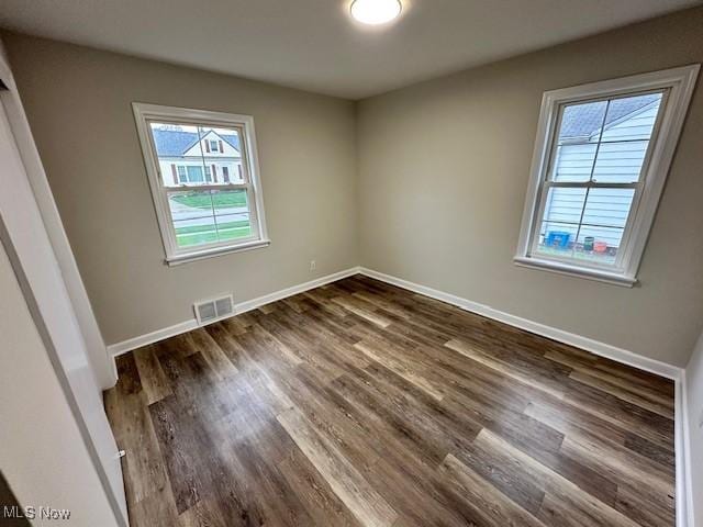 30119 Harrison St, Willowick, OH 44095 - empty room featuring visible vents, dark wood finished floors, and baseboards