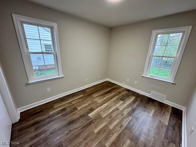30119 Harrison St, Willowick, OH 44095 - unfurnished room featuring visible vents, dark wood finished floors, and baseboards