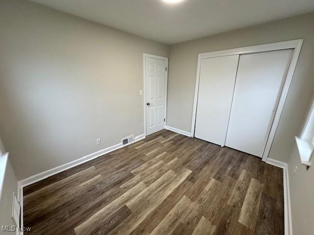 30119 Harrison St, Willowick, OH 44095 - unfurnished bedroom featuring baseboards, a closet, dark wood-style floors, and visible vents