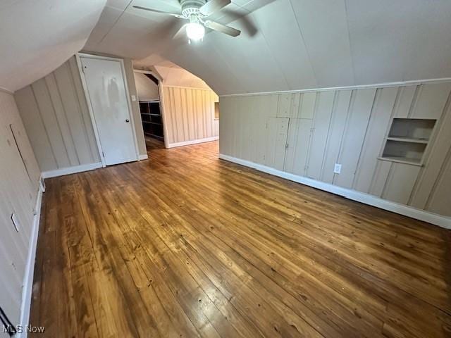 30119 Harrison St, Willowick, OH 44095 - bonus room featuring wooden walls, a ceiling fan, hardwood / wood-style floors, and lofted ceiling