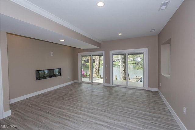 unfurnished living room featuring light wood-style floors, baseboards, and recessed lighting