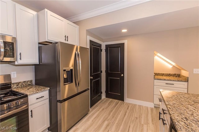 kitchen with crown molding, light stone countertops, light wood-type flooring, white cabinets, and stainless steel appliances