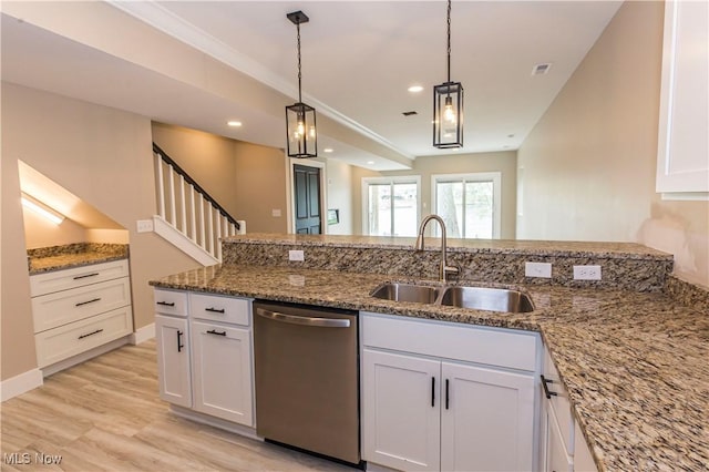 kitchen with pendant lighting, dishwasher, a sink, stone counters, and white cabinetry