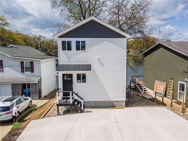 view of front of house featuring roof with shingles and entry steps