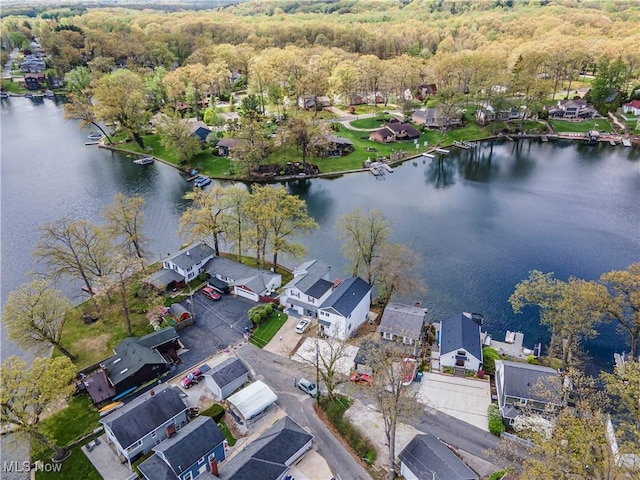 bird's eye view with a residential view, a water view, and a wooded view