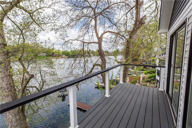 wooden terrace featuring a water view