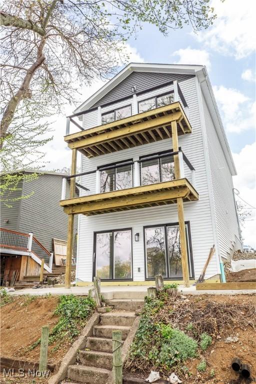 back of property with a balcony