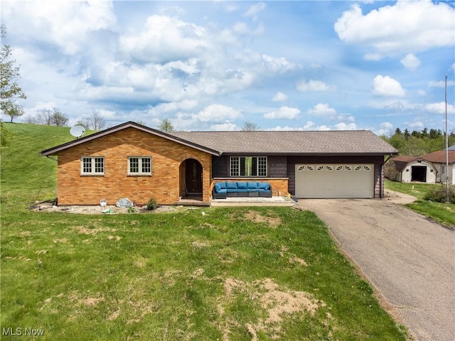 single story home with driveway, an outdoor living space, a front yard, brick siding, and an attached garage