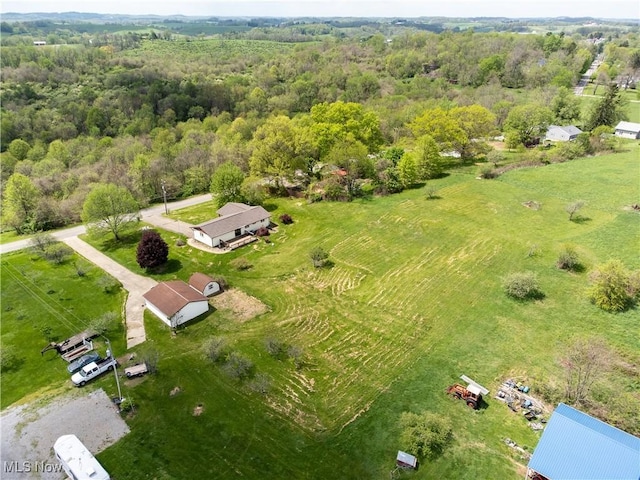 drone / aerial view with a view of trees and a rural view