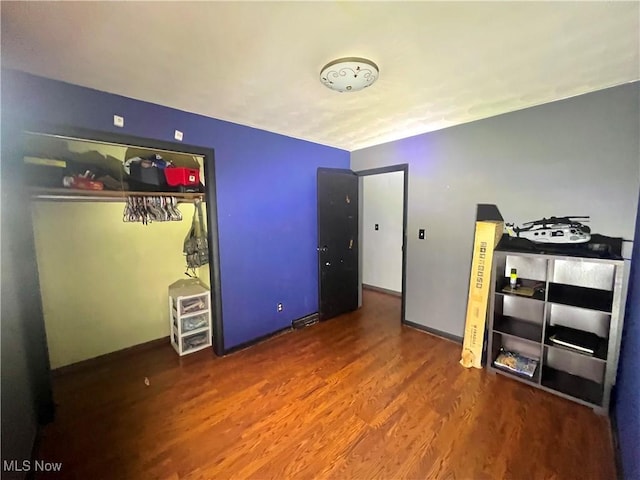 unfurnished bedroom featuring baseboards and wood finished floors