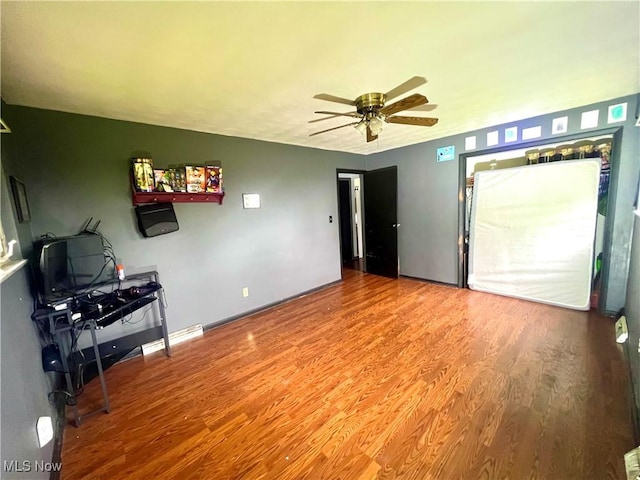 interior space featuring ceiling fan and wood finished floors