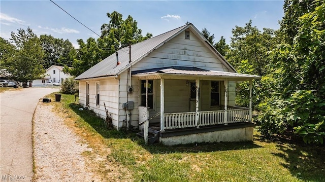 bungalow featuring covered porch and metal roof