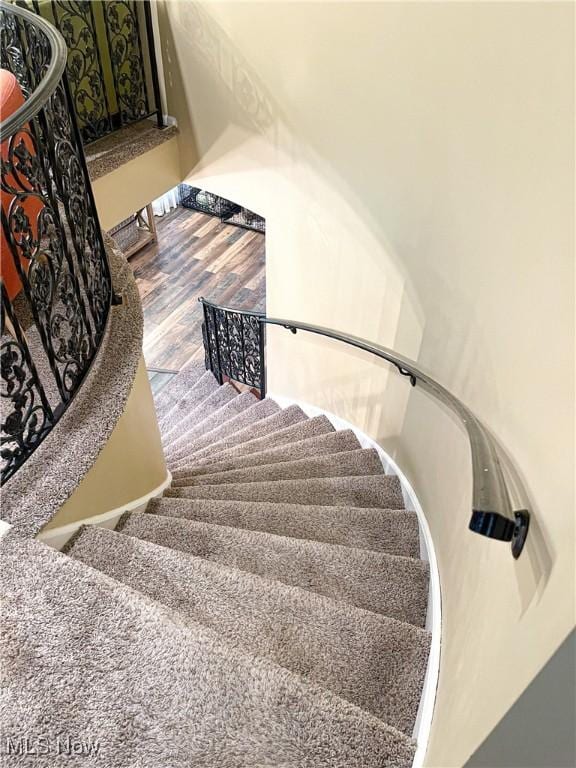 staircase with wood finished floors