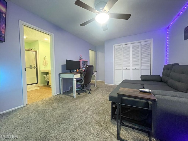 carpeted home office with baseboards and a ceiling fan