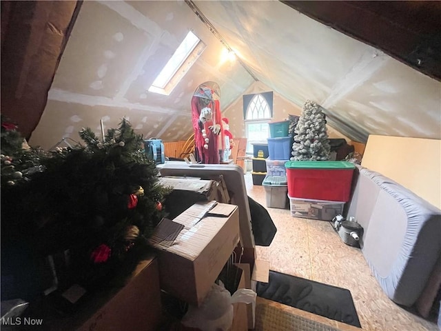 bonus room featuring lofted ceiling with skylight
