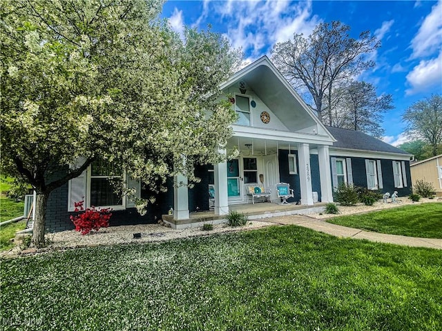 greek revival house with covered porch and a front yard