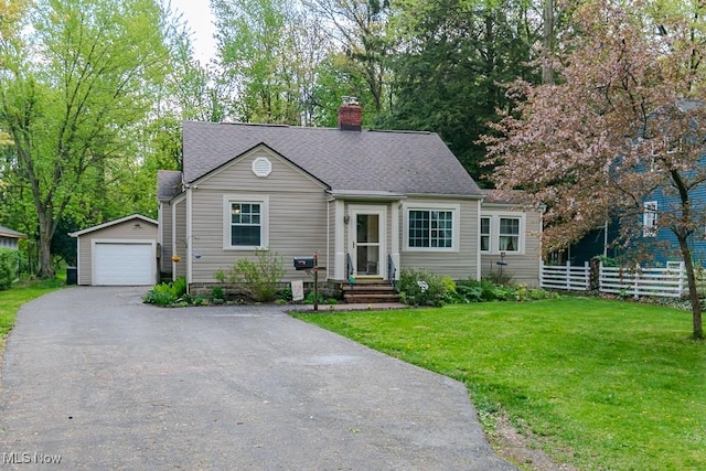 7599 Fairview Ave, Mentor, OH 44060 - view of front of home with fence, a garage, a front yard, an outbuilding, and a chimney