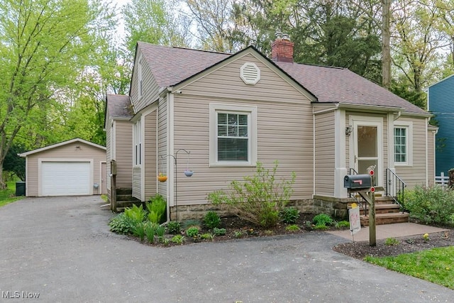 7599 Fairview Ave, Mentor, OH 44060 - bungalow with a shingled roof, an outbuilding, a chimney, and a detached garage