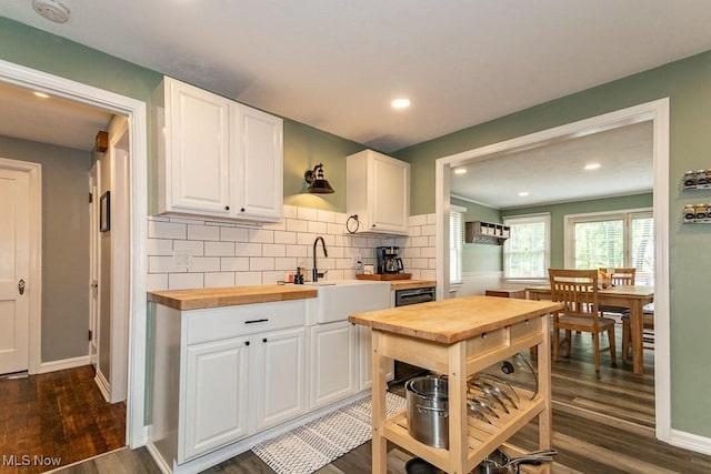7599 Fairview Ave, Mentor, OH 44060 - kitchen featuring wooden counters, dark wood-type flooring, white cabinets, tasteful backsplash, and a sink