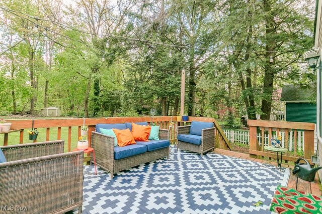 7599 Fairview Ave, Mentor, OH 44060 - wooden deck with an outdoor structure, an outdoor living space, and a shed
