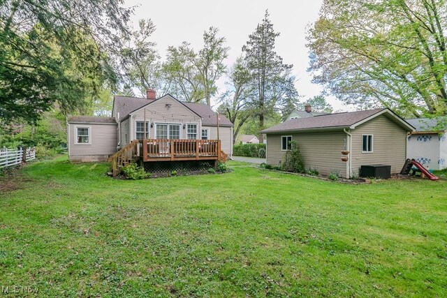 7599 Fairview Ave, Mentor, OH 44060 - rear view of house with a lawn, a deck, and central AC