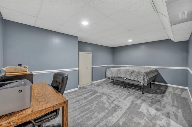 office area featuring carpet floors, recessed lighting, baseboards, a drop ceiling, and visible vents