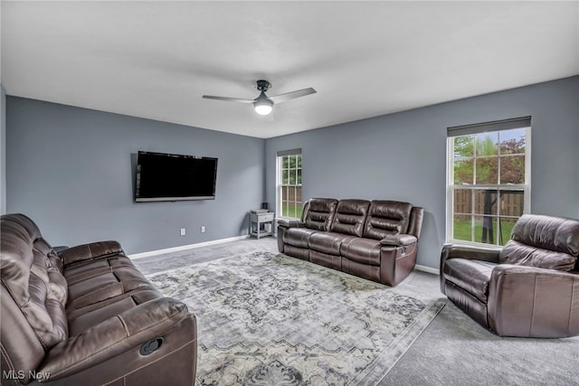 living room featuring carpet flooring, baseboards, and plenty of natural light