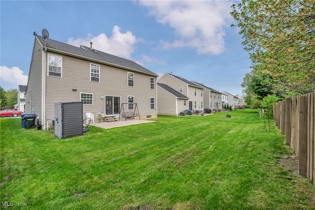 back of property with a residential view, fence, a yard, a patio, and entry steps