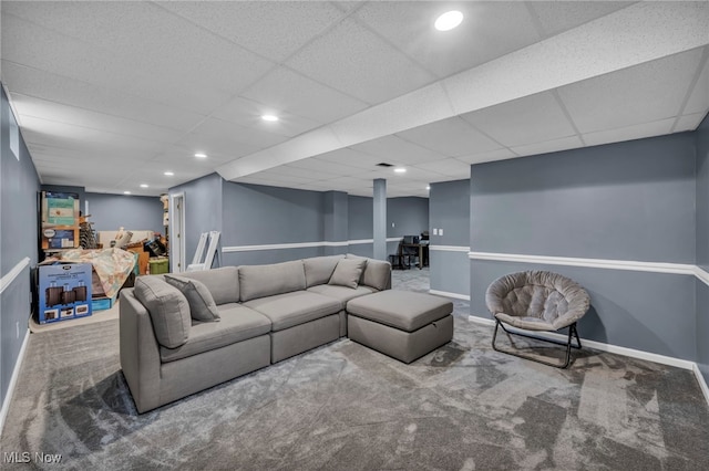 carpeted living area with baseboards, recessed lighting, and a paneled ceiling