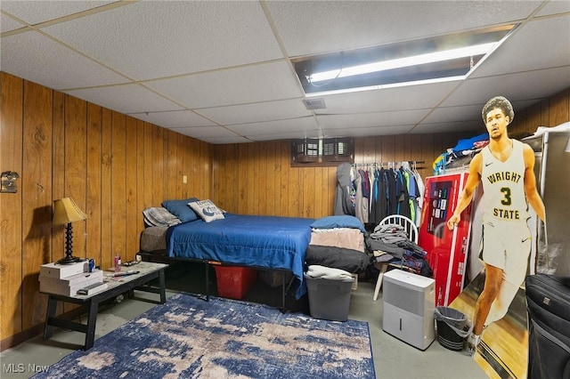 1536-1548 Montclair St NE, Warren, OH 44483 - bedroom with finished concrete floors, a paneled ceiling, and wooden walls