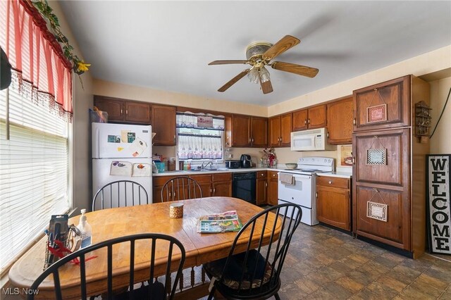 1536-1548 Montclair St NE, Warren, OH 44483 - kitchen featuring stone finish floor, a ceiling fan, light countertops, a sink, and white appliances