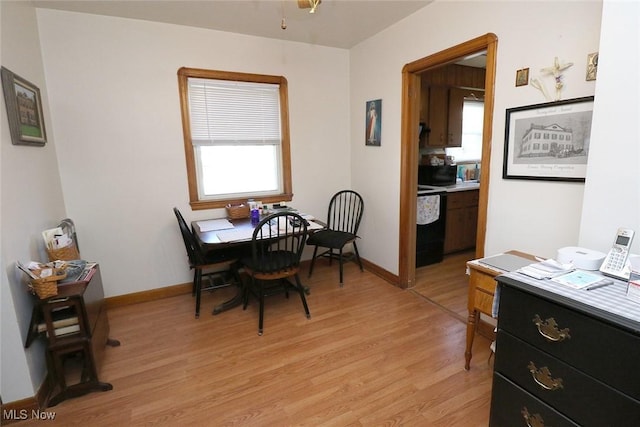 dining room with baseboards and light wood-style floors