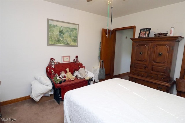 bedroom featuring carpet floors, a ceiling fan, and baseboards