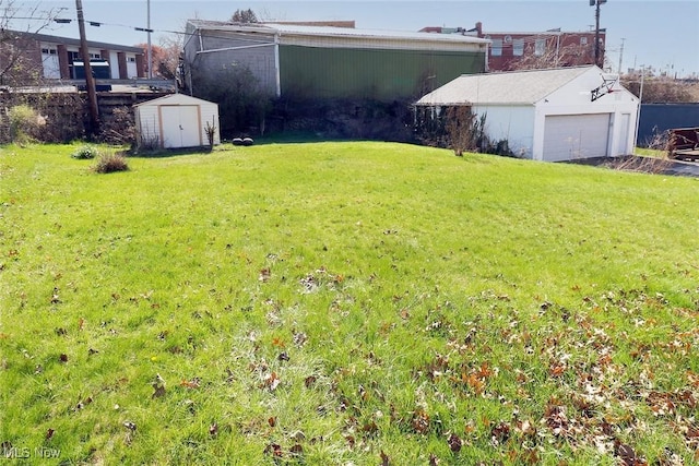 view of yard with an outdoor structure, a garage, and a storage shed