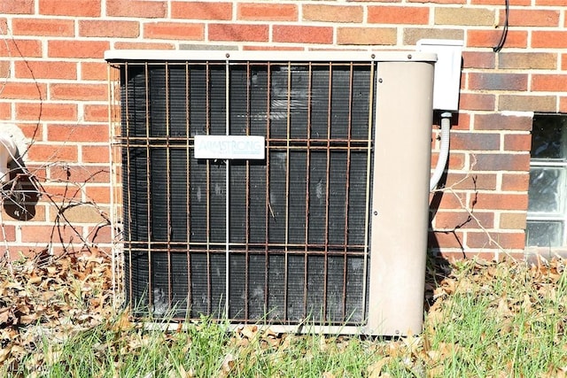details with central air condition unit and brick siding
