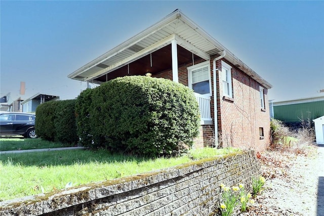 view of property exterior featuring brick siding