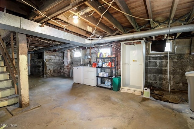 below grade area featuring stairs, washing machine and dryer, and a wealth of natural light
