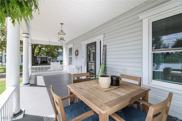 view of patio with a porch and outdoor dining space