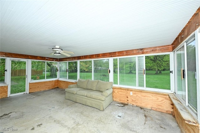 unfurnished sunroom with ceiling fan